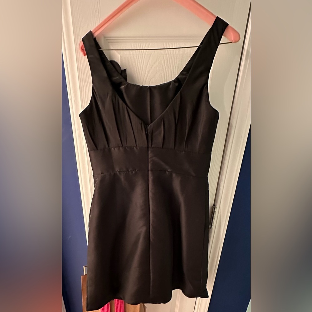 Little black dress, pockets, cute flower, hits just above the knee, size 10/12